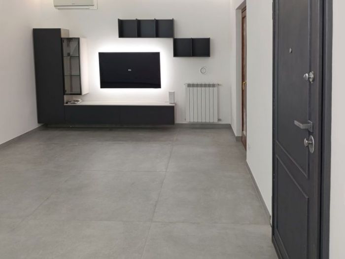 Archisio - Mani Srl Ristrutturazini - Progetto Ristrutturazione salone con parete attrezzata roma Zona axa casalpalocco